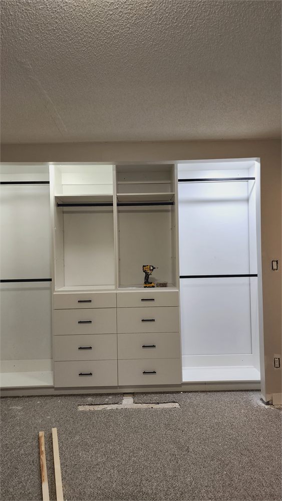 New built-in closet organizer with drawers and hanging rods