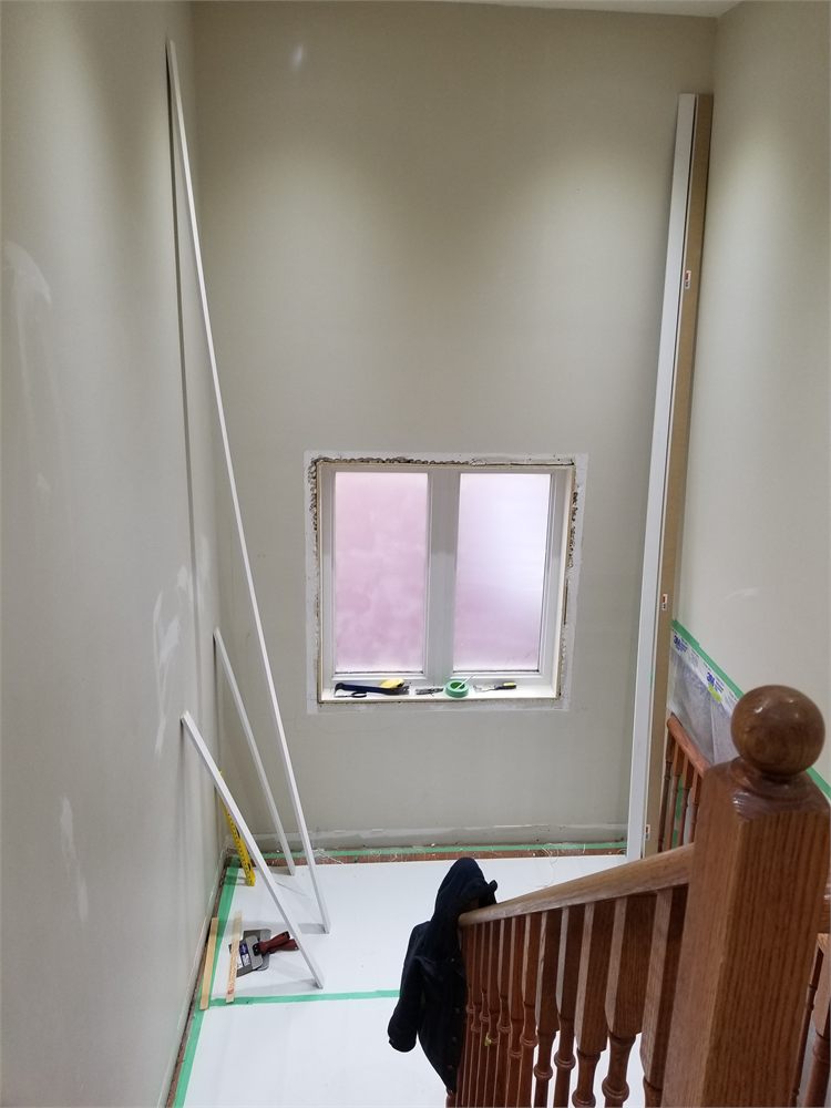 Stairwell wall with a window before the wainscoting install