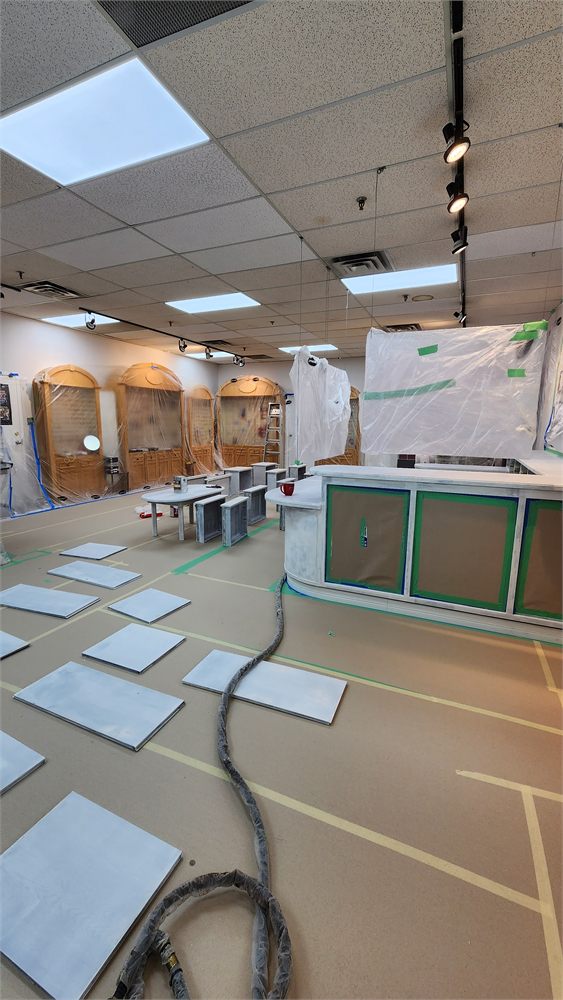 Store counter and display cabinets masked and primed for refinishing